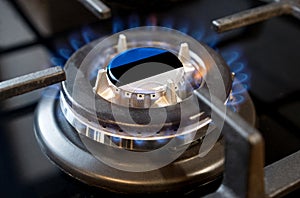 A burning gas burner of a home stove, in the middle of which a flag is depicted - Estonia