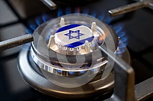 A burning gas burner of a home stove, in the middle of which a flag is depicted - Israel