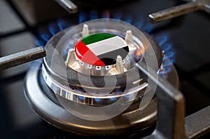 A burning gas burner of a home stove, in the middle of which a flag is depicted - UAE