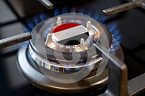 A burning gas burner of a home stove, in the middle of which a flag is depicted - Yemen