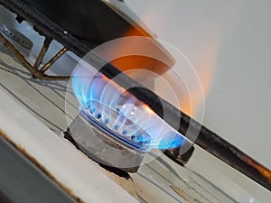 Burning gas on an old stove, blue fuel