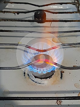 Burning gas on an old stove, blue fuel