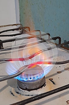 Burning gas on an old stove, blue fuel