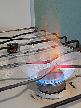 Burning gas on an old stove, blue fuel