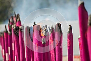 Burning giant incense sticks at temple.