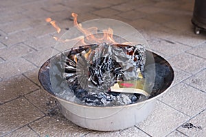 A burning golden paper. A chinese ritual