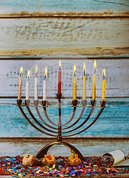Burning hanukkah candles in a menorah on colorful candles from a menorah photo