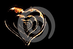 Burning heart with flames. Isolated on dark background. fire show in night. happy valentine`s day card. bengal fire burning heart