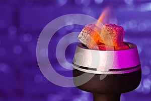 Burning hookah coals in hookah bowl close up