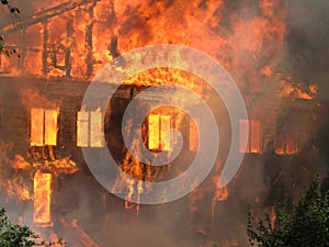 Burning house. Big wooden building completely destroyed by fire