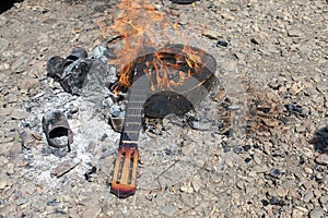 Burning household trash. abandoned rubbish, bottles and unburnt fire after picnic. garbage after tourists