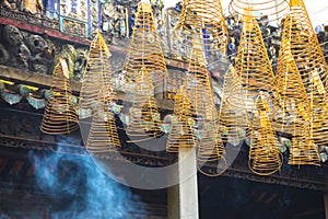 Burning incense sticks hanging from the ceiling of Chua Ba Thien Hau pagoda in Ho Chi Minh, Vietnam.