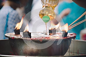 Burning Joss stick and oil palm candle at chinese shrine for making merit in chinese new year festival. Pray for New