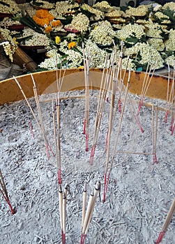 Burning Joss Sticks in brass pot in the temple