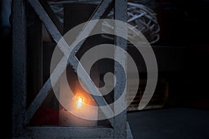 Burning kerosene lamp over dark background