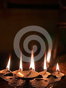 Burning lamp or diya during hindu rituals flame called Aarti. shiva Aarti pic. Aarti flame given to the gods at night time.