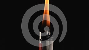 Burning lighter on black background. Macro shot of a tongue of fire burning from igniting a lighter. Mesmerizing