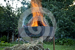 Burning logs in a brazier. Picnic time