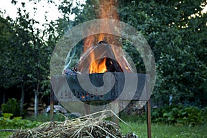 Burning logs in a brazier. Picnic time