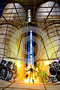 Burning Man Light Painted With Fire in Industrial Setting