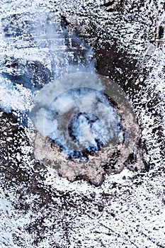 Burning manure pile at farm, air pollution and contamination, aerial shot from drone pov