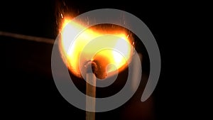 Burning match, bright firelight