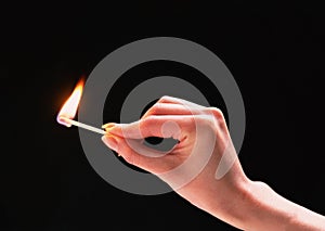 A burning match in a hand