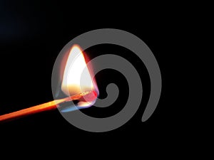 Burning match in hand on neutral background