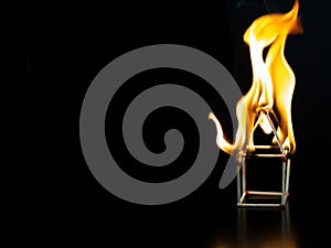 Burning match house with black background, fire house model property Insurance