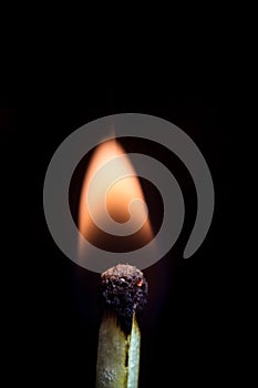 Burning match isolated on a black background, macro image.