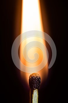 Burning match isolated on a black background, macro image.