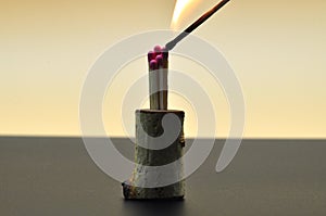 A burning match near other matches