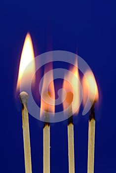 Burning Matches On Blue Background