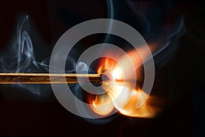 Burning matchstick, black background