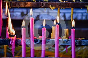 Burning molten prayer candles in a temple in Thailand