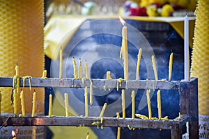 Burning molten prayer candles in a temple in Thailand