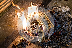 Burning money - 100 american dollar banknotes in flames