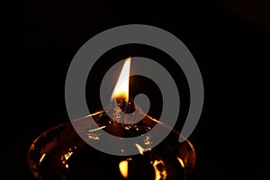 Burning oil lamp and fire with dark background. Closeup.