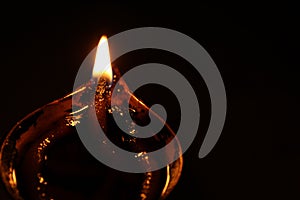 Burning oil lamp and fire with dark background. Closeup.