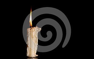 Burning Old Candle on Black Background.