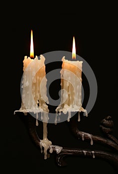 Burning old candle vintage Silver bronze candlestick. Isolated Black Background.