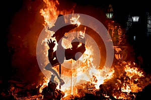 Burning paper mache cowboy statue at the Fallas festival in Gandia, Spain