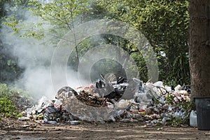 Burning pile of garbage, cause of air pollution