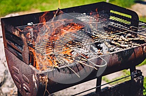 Burning and preheating old rusty barbecue grill cleaning dirty g