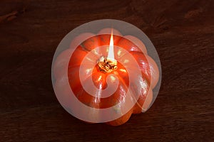 burning pumpkin-shaped candle