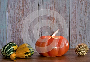 Burning pumpkin-shaped candle