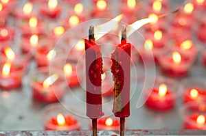 Burning red candle at chinese shrine for making merit in chinese