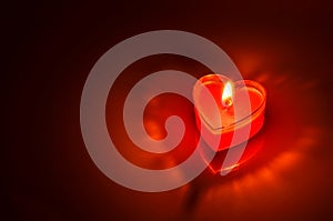 Burning red candle heart