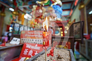 Burning red candles in a burner of a Chinese taoist Ancestral temple, Chiang Mai, Thailand