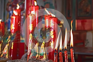 Burning red candles in Thai Temple, Thailand